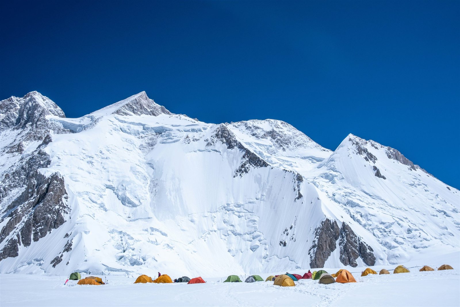 The ice face of Gasherbrum catching cloud above the glacier