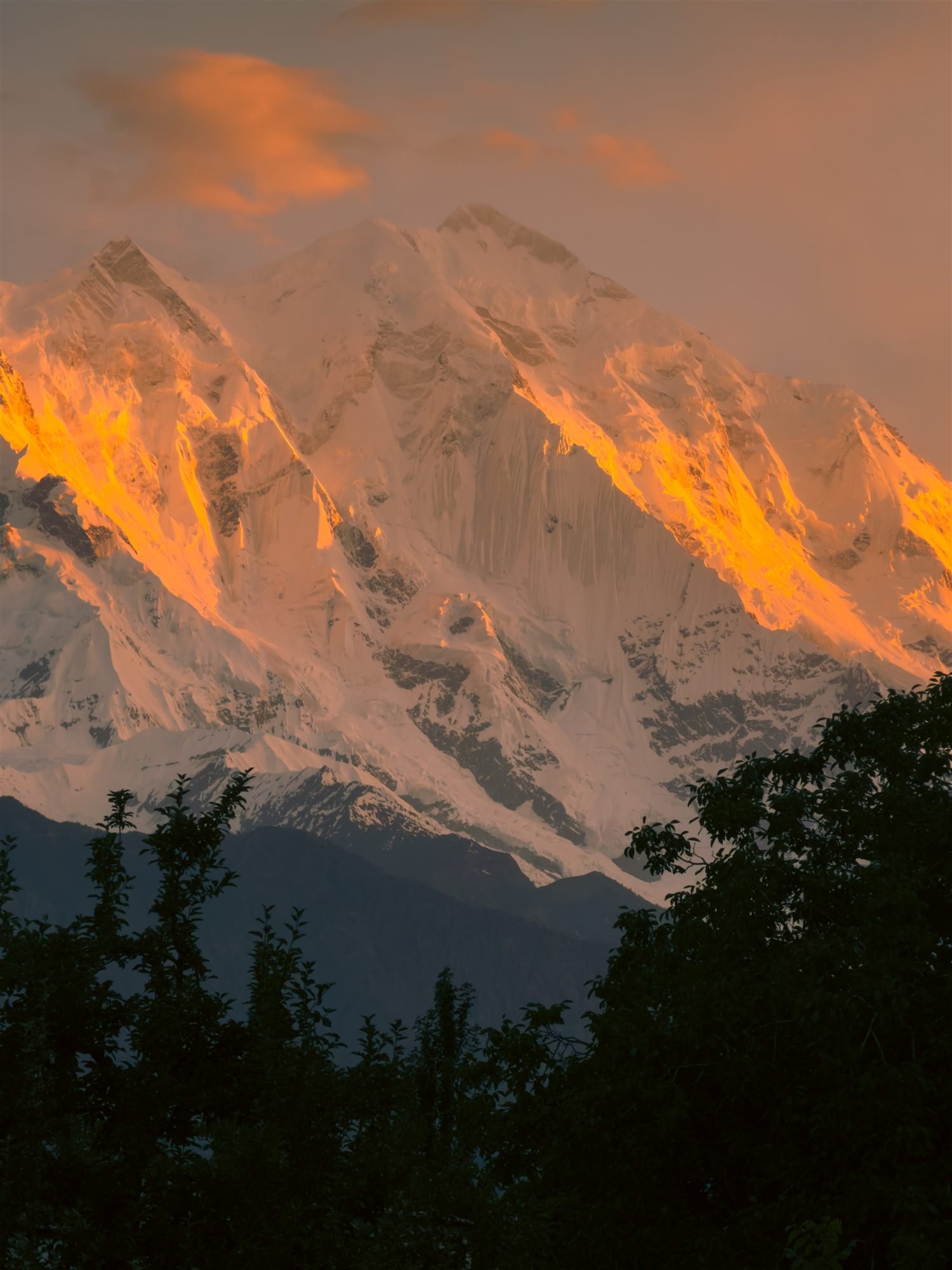 Alpenglow lighting the ridgelines of a snow peak above Hunza at sunset