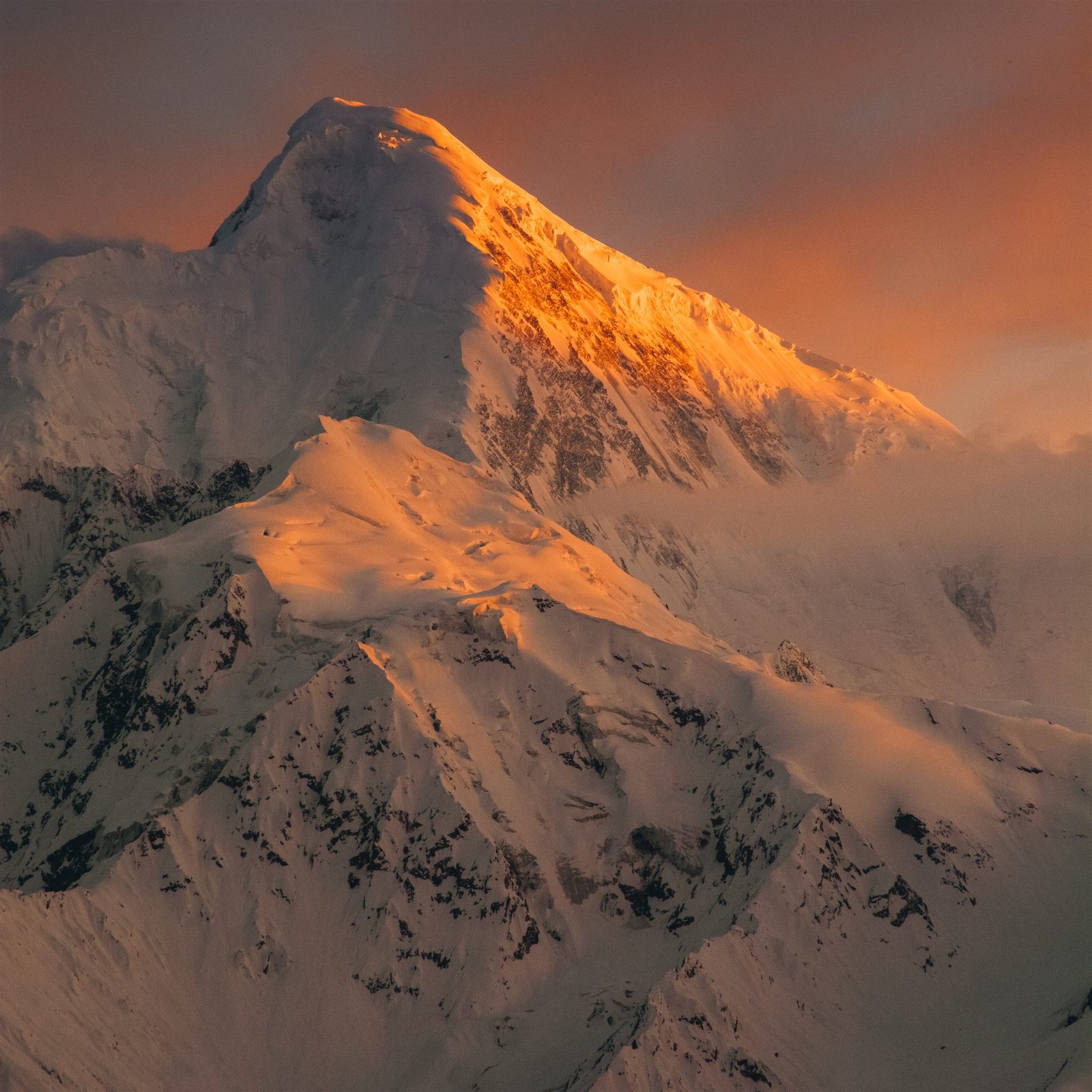 Sunset light striking the upper ridges of a Karakoram peak above Hunza