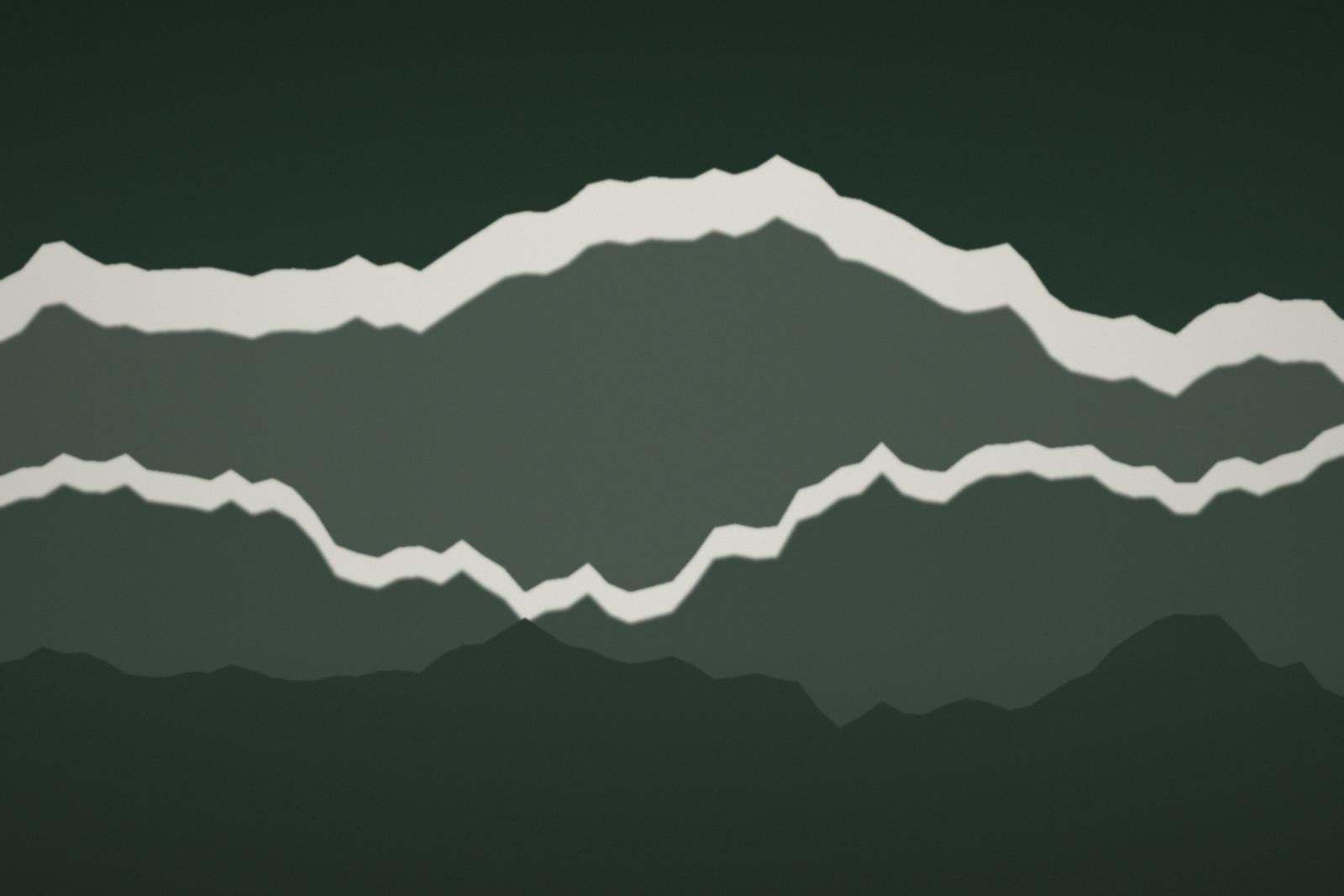 A wall of peaks above a valley under a pale sky
