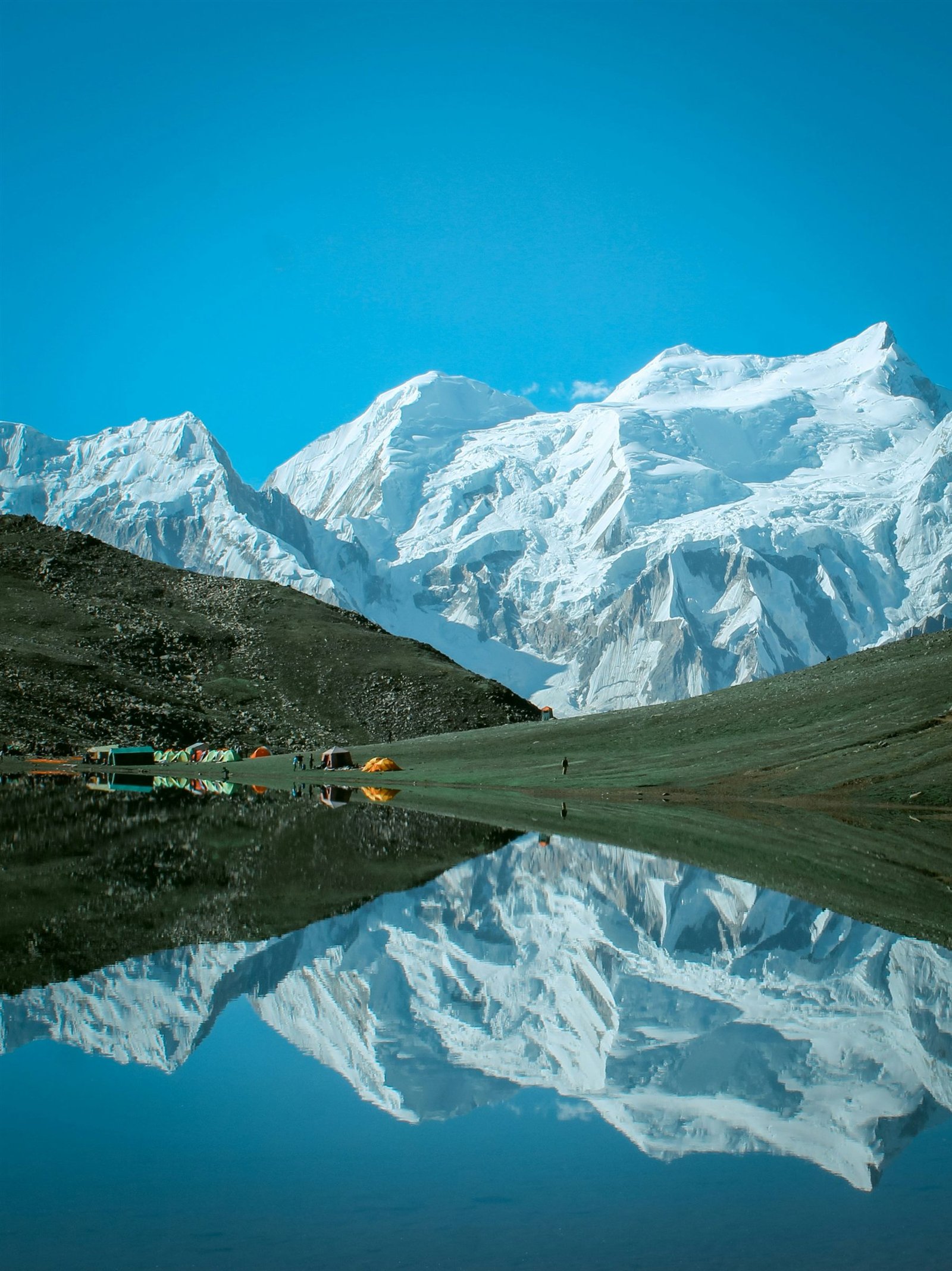 Tents beside Rush Lake reflecting the snow peak above